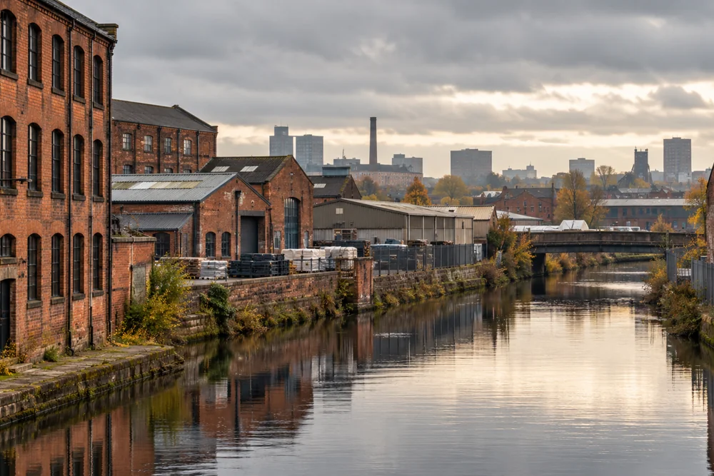 Brick industrial buildings alongside a Greater Manchester style canal